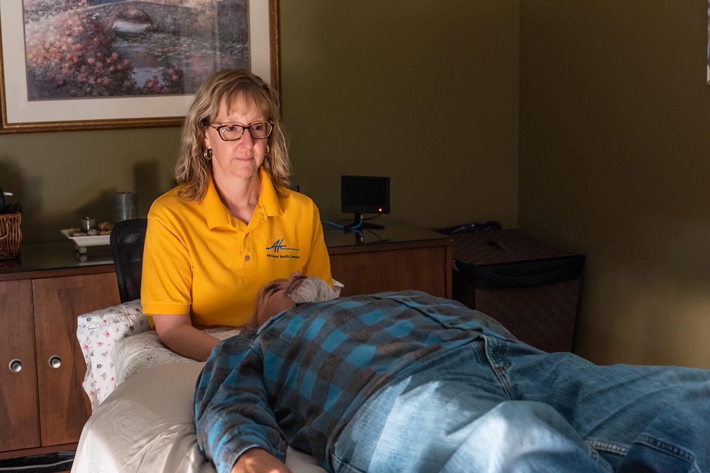 Practitioner providing gentle craniosacral therapy to support relief from chronic pain and nervous system tension